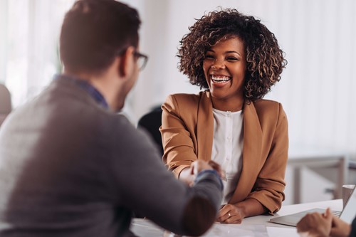 two people shaking hands after a deal